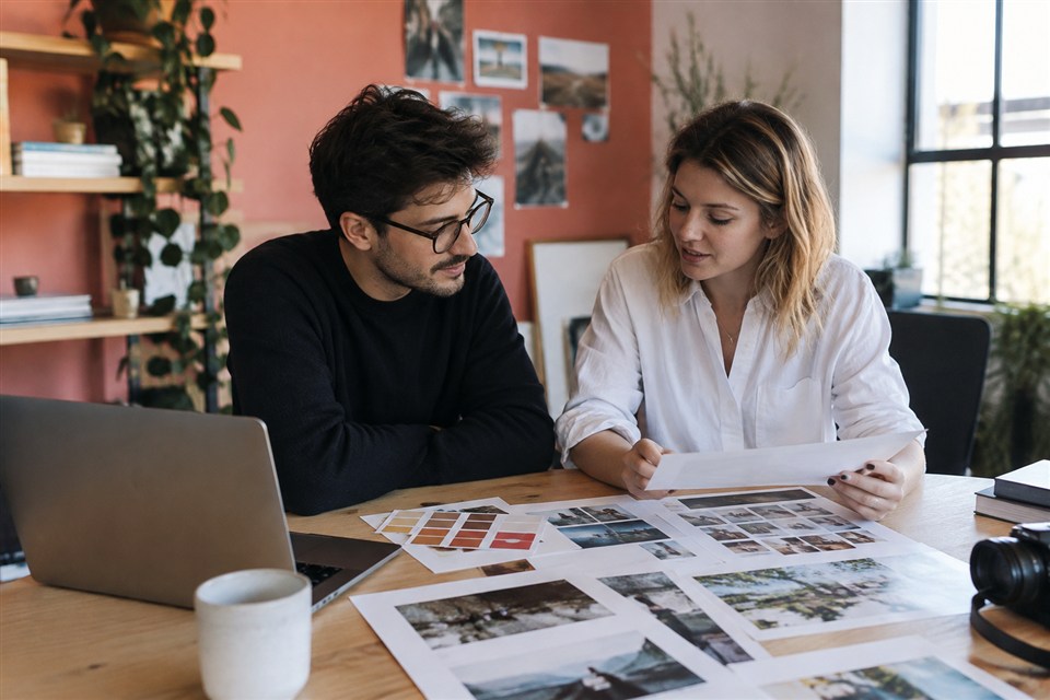 Coworkers reviewing campaign photographs